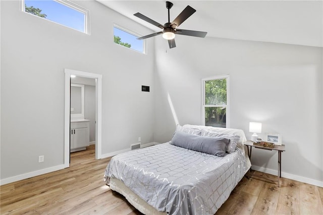 11917 W 66th St, Shawnee, KS 66216 - bedroom with light wood-type flooring, a high ceiling, and a ceiling fan