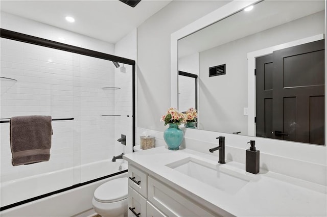 11917 W 66th St, Shawnee, KS 66216 - bathroom featuring vanity, shower / bath combination with glass door, and recessed lighting
