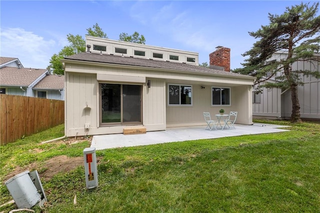 11917 W 66th St, Shawnee, KS 66216 - rear view of house with a chimney and a patio area