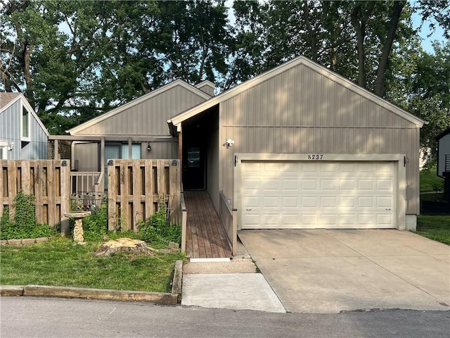 8237 N Chatham Ave, Kansas City, MO 64151 - view of front facade with an attached garage and driveway