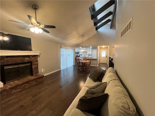 8237 N Chatham Ave, Kansas City, MO 64151 - living room with ceiling fan, dark wood-style floors, baseboards, a glass covered fireplace, and high vaulted ceiling