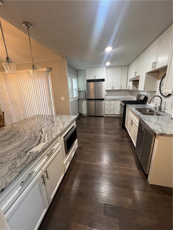 8237 N Chatham Ave, Kansas City, MO 64151 - kitchen with stainless steel appliances, a sink, light stone countertops, under cabinet range hood, and white cabinets