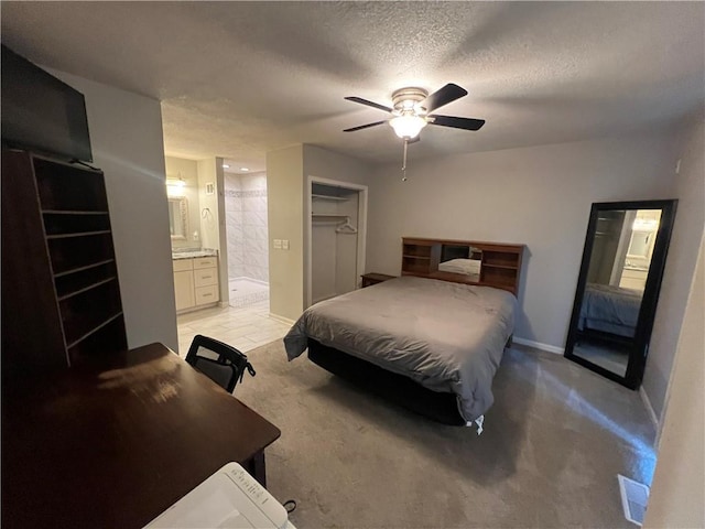 8237 N Chatham Ave, Kansas City, MO 64151 - bedroom with a textured ceiling, ensuite bath, baseboards, a ceiling fan, and light carpet