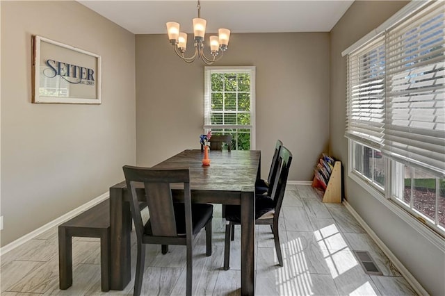 3403 E Devonshire Dr, Saint Joseph, MO 64506 - dining area with a chandelier and baseboards