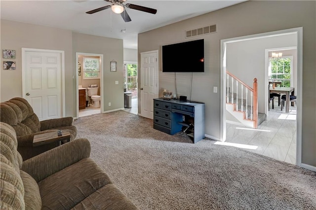 3403 E Devonshire Dr, Saint Joseph, MO 64506 - living room featuring a ceiling fan, carpet floors, stairway, and baseboards