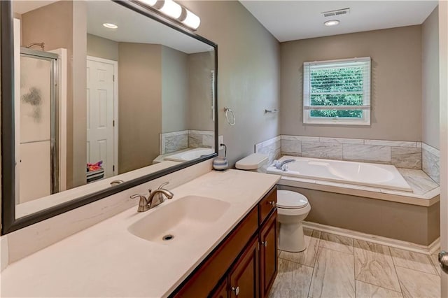 3403 E Devonshire Dr, Saint Joseph, MO 64506 - full bath with vanity, a bath, toilet, marble finish flooring, and a stall shower