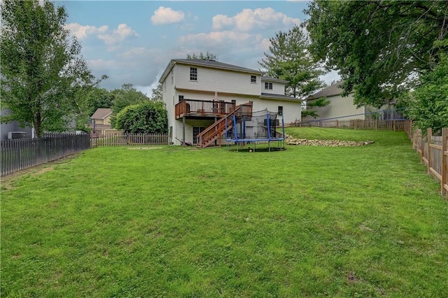 3403 E Devonshire Dr, Saint Joseph, MO 64506 - rear view of house featuring stairway, a deck, and a trampoline