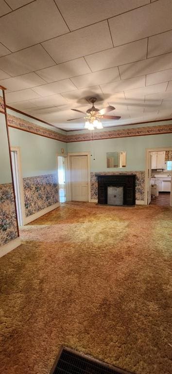 423 S Minnesota Ave, Columbus, KS 66725 - unfurnished living room with carpet flooring and a ceiling fan