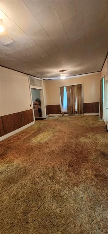 423 S Minnesota Ave, Columbus, KS 66725 - empty room with a wainscoted wall and wood walls