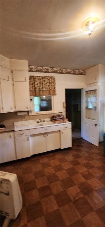 423 S Minnesota Ave, Columbus, KS 66725 - kitchen featuring white cabinetry and light countertops