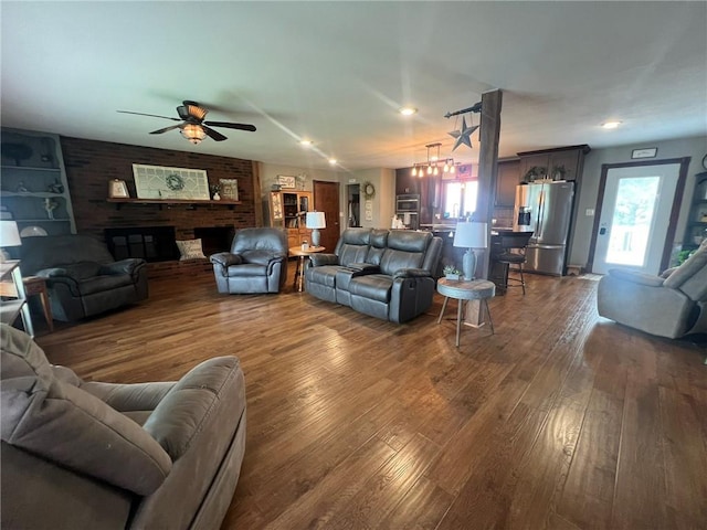 605 Queen St, King City, MO 64463 - living room featuring a ceiling fan and dark wood-style flooring