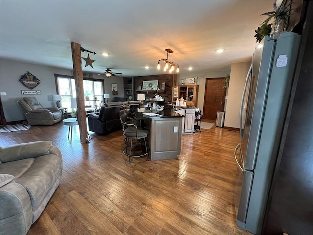605 Queen St, King City, MO 64463 - living area with wood finished floors, a ceiling fan, and recessed lighting