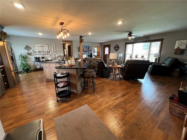 605 Queen St, King City, MO 64463 - living room featuring a ceiling fan, wood finished floors, and recessed lighting