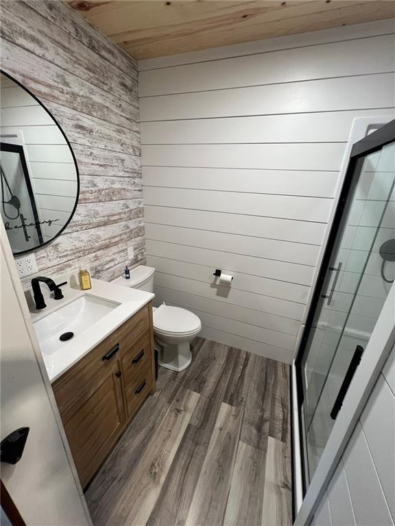 605 Queen St, King City, MO 64463 - full bath with wood walls, wood ceiling, vanity, wood finished floors, and a stall shower