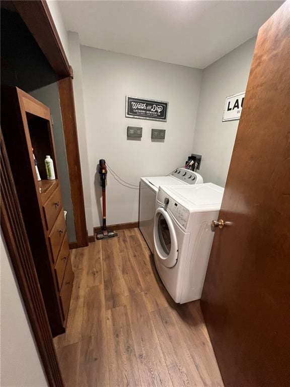 605 Queen St, King City, MO 64463 - laundry area featuring independent washer and dryer, light wood-type flooring, and baseboards