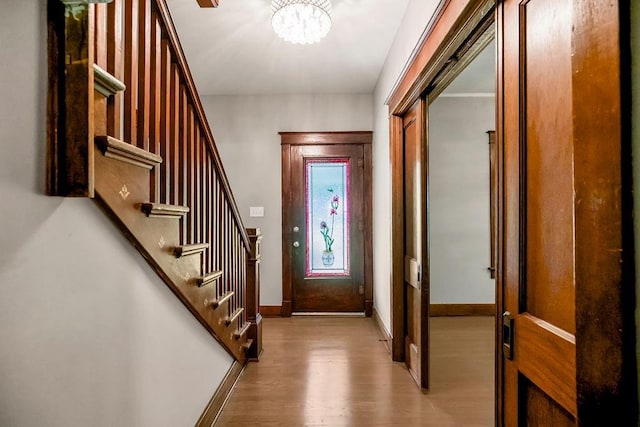 812 E Wabash St, Olathe, KS 66061 - entrance foyer with wood finished floors, a chandelier, and stairs