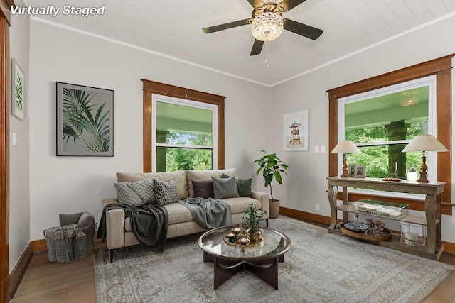 812 E Wabash St, Olathe, KS 66061 - living area featuring wood finished floors, ceiling fan, and crown molding
