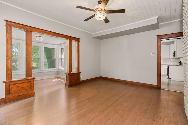 812 E Wabash St, Olathe, KS 66061 - empty room featuring wood finished floors, a ceiling fan, and ornamental molding