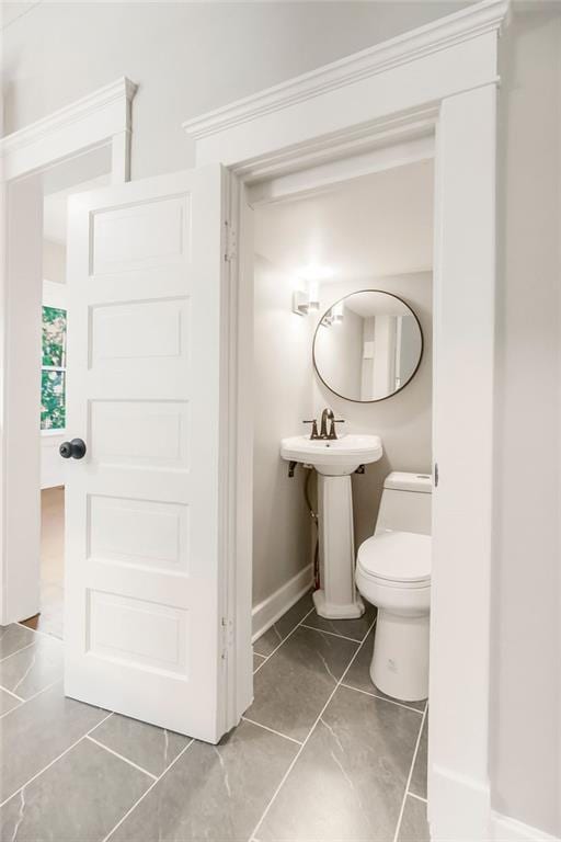 812 E Wabash St, Olathe, KS 66061 - half bath featuring baseboards and marble look tiles