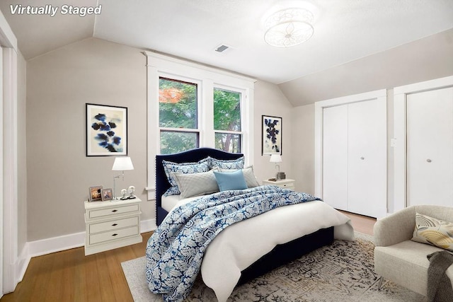 812 E Wabash St, Olathe, KS 66061 - bedroom featuring lofted ceiling, wood finished floors, and multiple closets