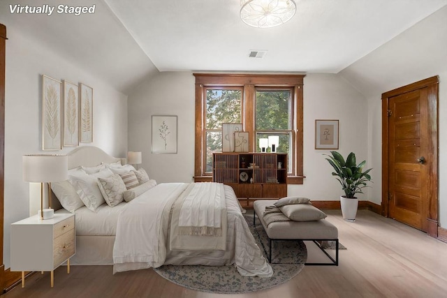 812 E Wabash St, Olathe, KS 66061 - bedroom featuring vaulted ceiling and wood finished floors