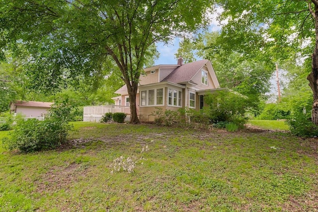 812 E Wabash St, Olathe, KS 66061 - view of property exterior with a chimney and a yard