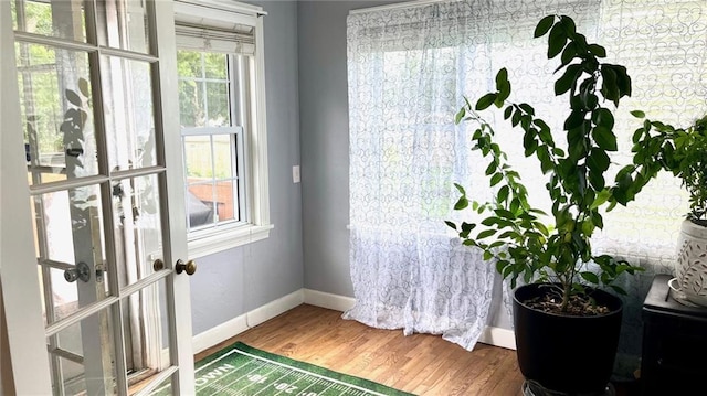 1146 S Willow St, Ottawa, KS 66067 - doorway to outside with baseboards and wood finished floors