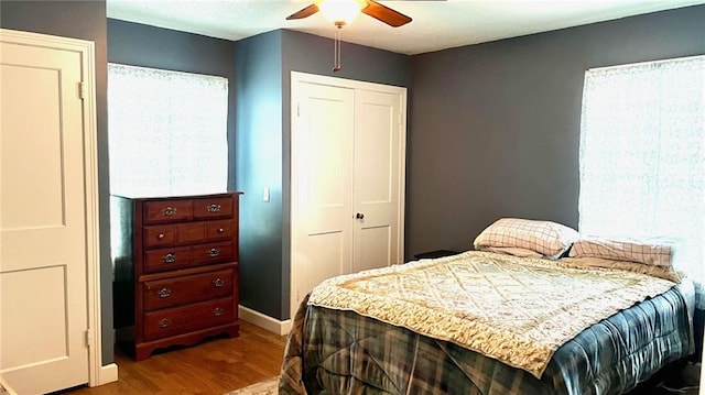 1146 S Willow St, Ottawa, KS 66067 - bedroom with wood finished floors, a closet, baseboards, and ceiling fan