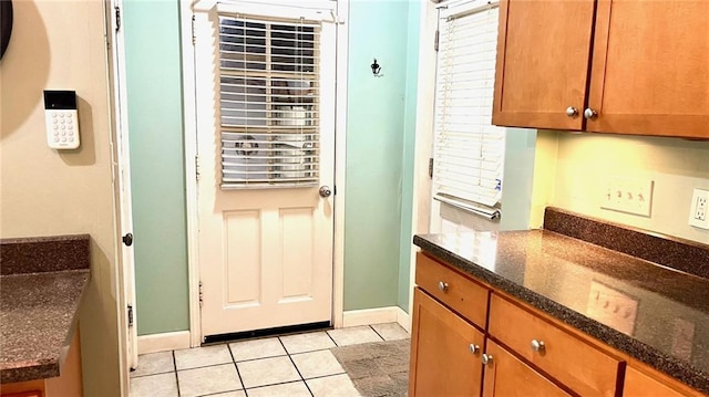 1146 S Willow St, Ottawa, KS 66067 - doorway to outside featuring light tile patterned flooring and baseboards