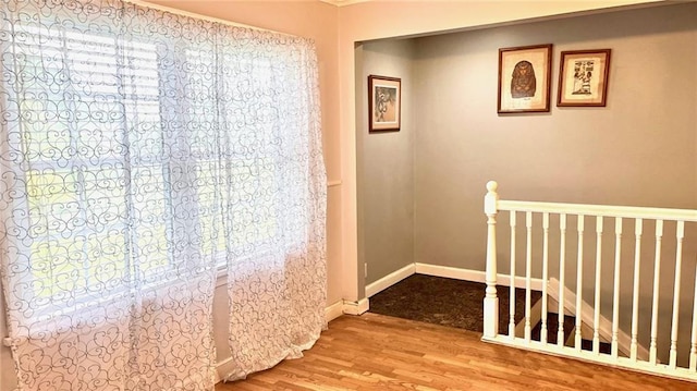 1146 S Willow St, Ottawa, KS 66067 - hall featuring an upstairs landing, wood finished floors, and baseboards