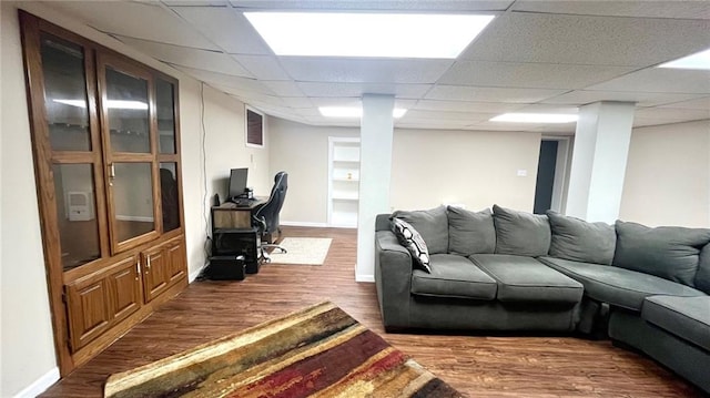 1146 S Willow St, Ottawa, KS 66067 - living area featuring wood finished floors, a paneled ceiling, and baseboards