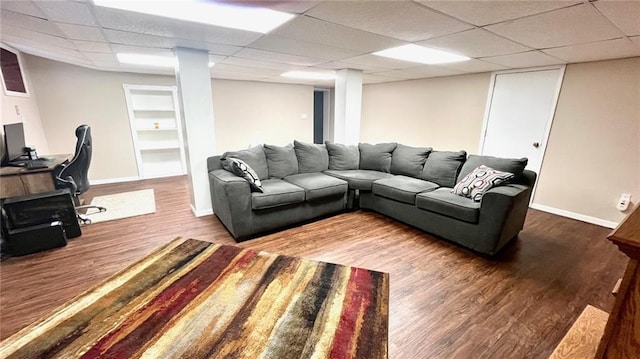 1146 S Willow St, Ottawa, KS 66067 - living room with baseboards, a paneled ceiling, and wood finished floors