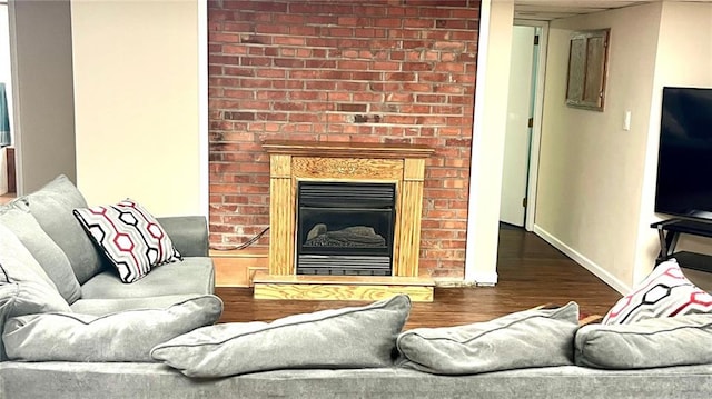 1146 S Willow St, Ottawa, KS 66067 - living area with wood finished floors, a fireplace, and baseboards