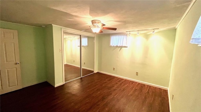 1146 S Willow St, Ottawa, KS 66067 - unfurnished bedroom with wood finished floors, crown molding, track lighting, a closet, and baseboards