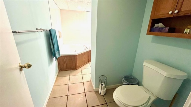 1146 S Willow St, Ottawa, KS 66067 - bathroom featuring tile patterned floors, toilet, a bath, and baseboards