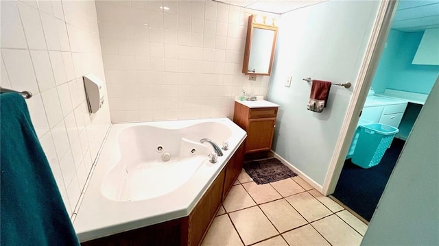 1146 S Willow St, Ottawa, KS 66067 - full bathroom with a whirlpool tub, vanity, tile walls, and tile patterned floors