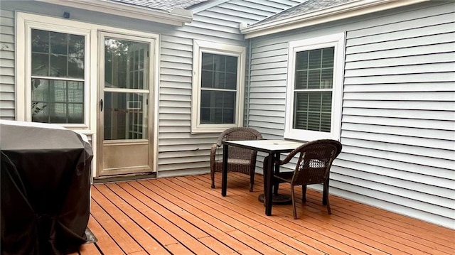 1146 S Willow St, Ottawa, KS 66067 - wooden deck with outdoor dining space and a grill