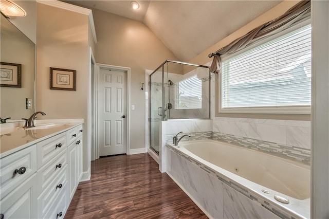 12207 England St, Overland Park, KS 66213 - bathroom featuring vanity, vaulted ceiling, a shower stall, a bath, and wood finished floors