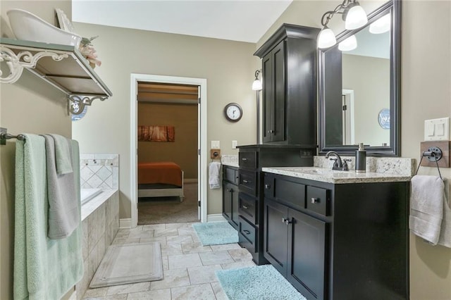 16570 S Ingrid St, Gardner, KS 66030 - full bathroom featuring vanity, a bath, stone finish floors, connected bathroom, and baseboards