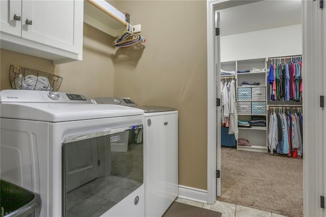 16570 S Ingrid St, Gardner, KS 66030 - laundry room featuring independent washer and dryer, cabinet space, light colored carpet, light tile patterned floors, and baseboards