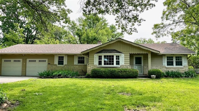 1441 S Maple St, Ottawa, KS 66067 - ranch-style home with stone siding, a garage, a front yard, and driveway