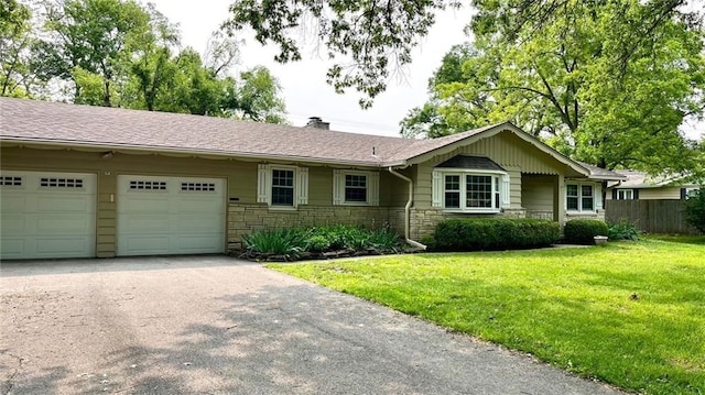 1441 S Maple St, Ottawa, KS 66067 - ranch-style home with stone siding, a garage, driveway, and a chimney