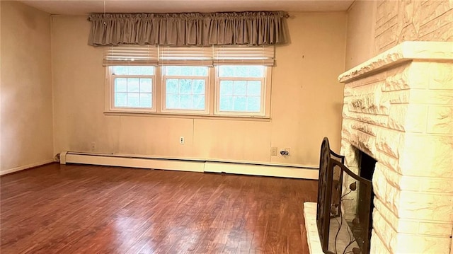 1441 S Maple St, Ottawa, KS 66067 - unfurnished living room with wood finished floors and baseboard heating