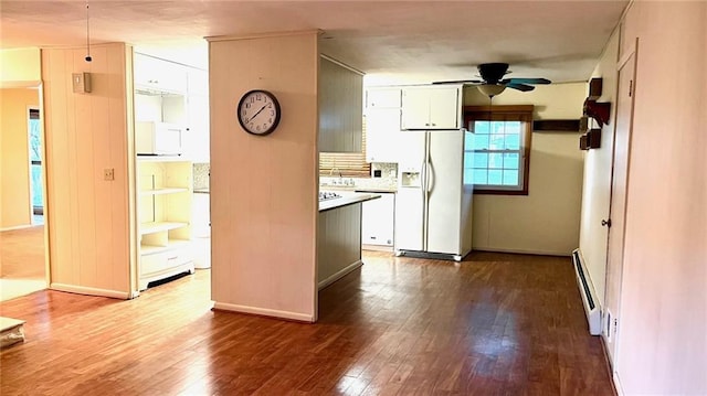 1441 S Maple St, Ottawa, KS 66067 - kitchen with white appliances, dark wood finished floors, a ceiling fan, and white cabinets