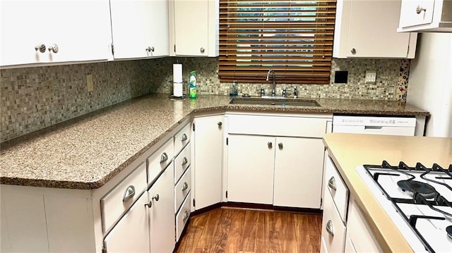 1441 S Maple St, Ottawa, KS 66067 - kitchen featuring white appliances, dark wood-type flooring, tasteful backsplash, and white cabinets