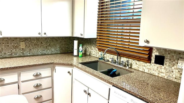 1441 S Maple St, Ottawa, KS 66067 - kitchen with backsplash, white cabinetry, light stone counters, and dishwasher