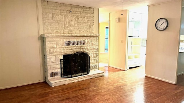 1441 S Maple St, Ottawa, KS 66067 - unfurnished living room with wood finished floors and a fireplace