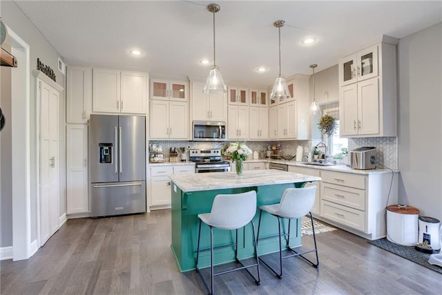 8721 N Mersington Ave, Kansas City, MO 64156 - kitchen with appliances with stainless steel finishes, white cabinetry, dark wood-style floors, backsplash, and recessed lighting