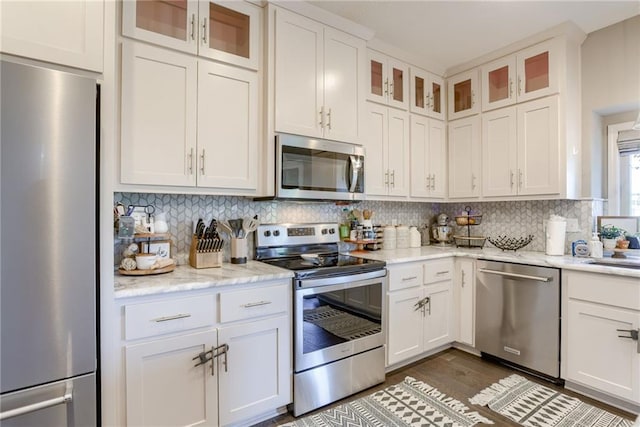 8721 N Mersington Ave, Kansas City, MO 64156 - kitchen featuring appliances with stainless steel finishes, backsplash, white cabinets, dark wood-style flooring, and light stone countertops
