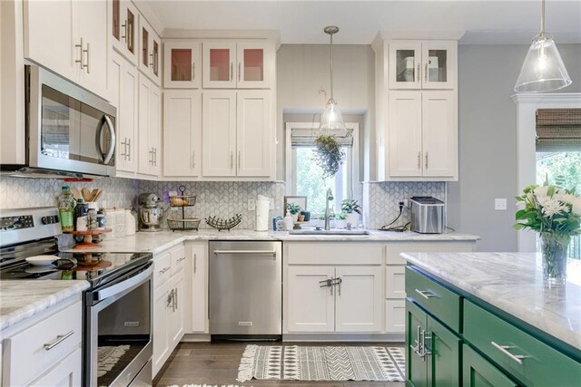8721 N Mersington Ave, Kansas City, MO 64156 - kitchen featuring stainless steel appliances, green cabinetry, white cabinets, tasteful backsplash, and light stone counters